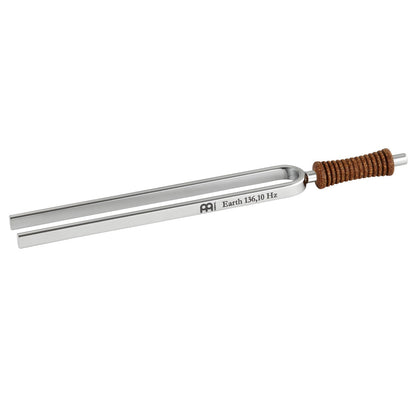 Single metal tuning fork with cork handle engraved Earth 136.10 Hz shown in close-up. — for Carpe Diem Dream