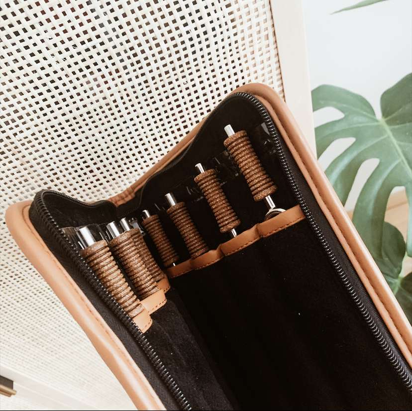 Portable seven chakra tuning fork travel case shown open at an angle with cork handle forks secured in fitted slots. — for Carpe Diem Dream
