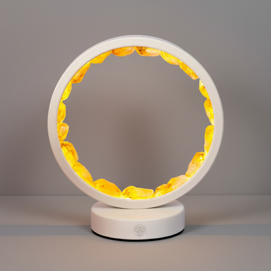 Citrine manifestation lamp centered on a softly textured studio wall and surface with natural shadow. — for Carpe Diem Dream