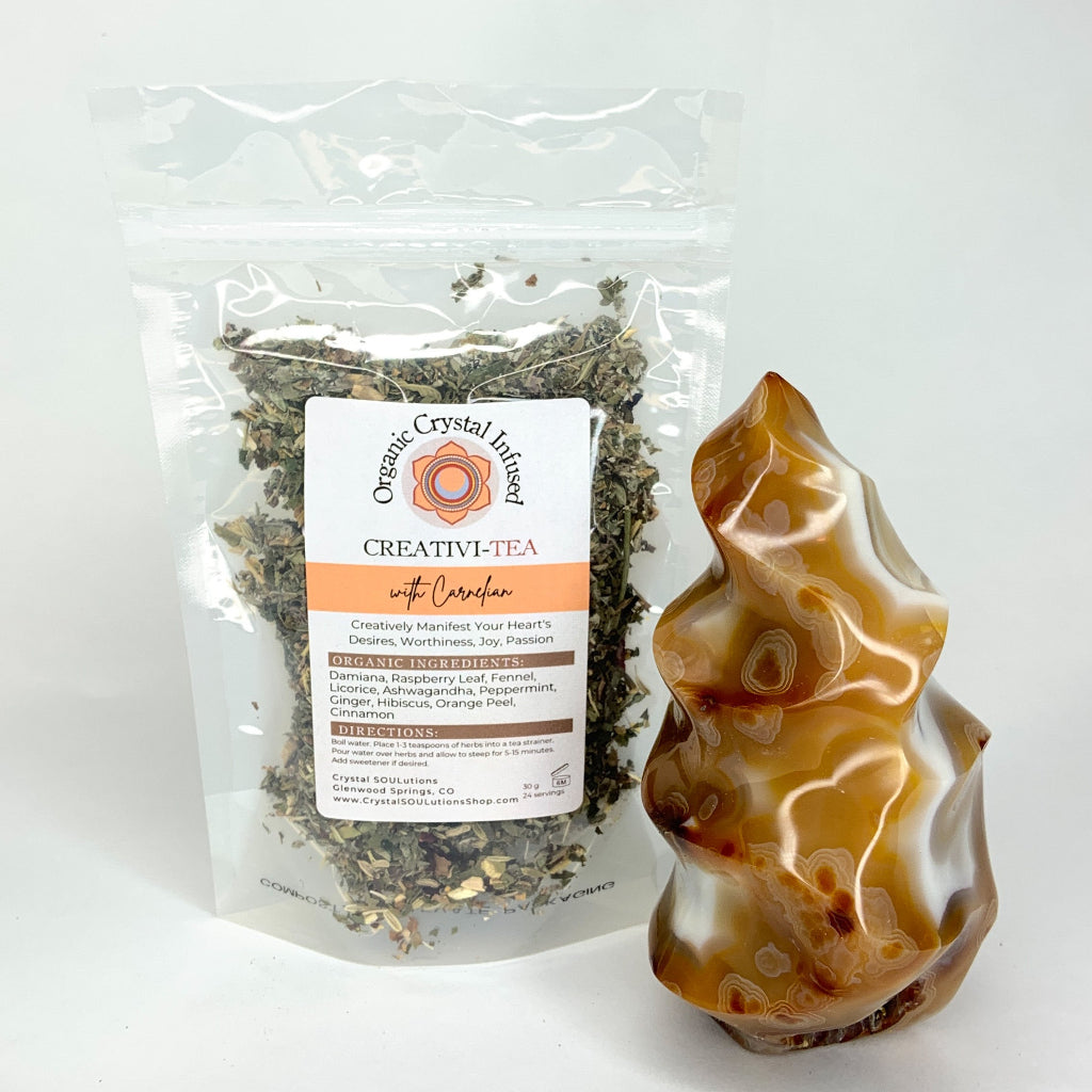 Creativi-Tea – Organic Crystal-Infused Herbal Tea with Carnelian in the authentic 30 g stand-up pouch supplier image, shown beside the original Carnelian crystal with the loose-leaf herbal blend, packaging, and label exactly as provided. — for Carpe Diem Dream