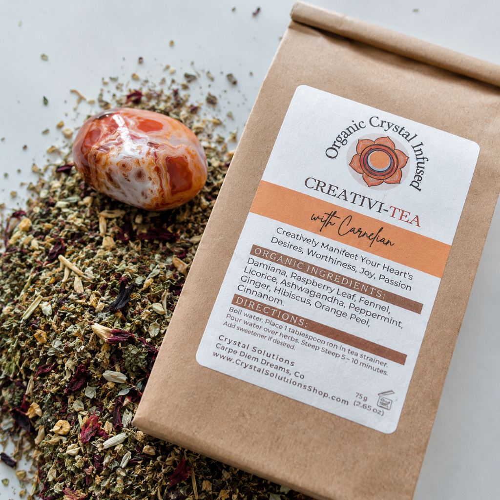 Creativi-Tea – Organic Crystal-Infused Herbal Tea with Carnelian shown in a close-up detail image highlighting the kraft paper packaging, product label, loose herbal blend, Carnelian crystal, and natural material textures. The product is photographed in cool diffused daylight with shallow depth of field and premium commercial styling. — for Carpe Diem Dream
