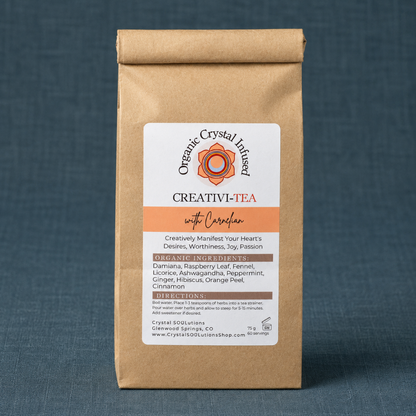 Creativi-Tea – Organic Crystal-Infused Herbal Tea with Carnelian displayed on a dark teal textured linen backdrop with matching linen surface, photographed in cool diffused daylight with soft natural shadows and premium commercial styling. The authentic product remains the sole focal point with no props. — for Carpe Diem Dream