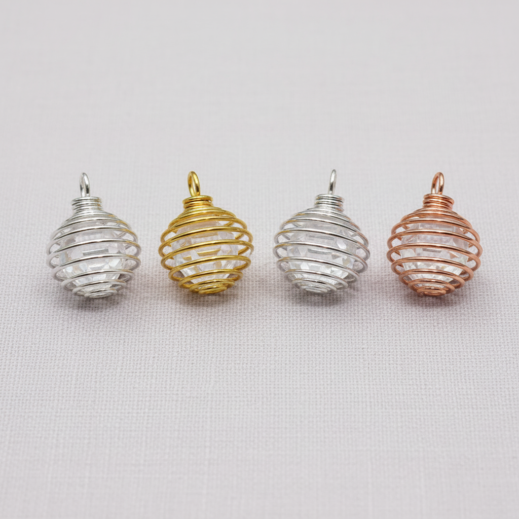 A close-up view of silver, gold, and copper spiral crystal cage pendants showing their wire craftsmanship and looped clasps. — for Carpe Diem Dream