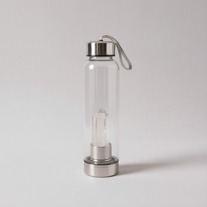 A clear glass crystal-infused water bottle featuring a transparent clear quartz point within the inner stainless steel chamber. — for Carpe Diem Dream