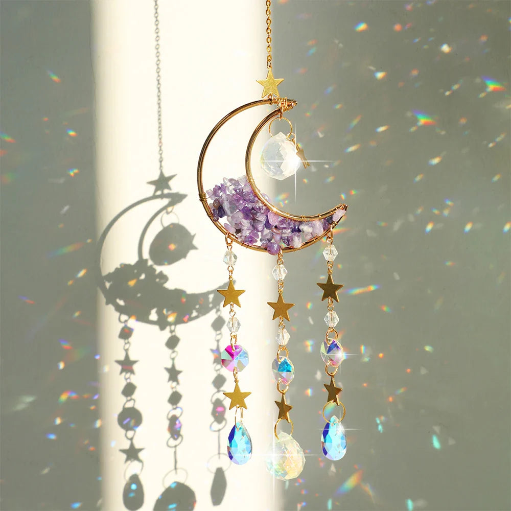 An amethyst crystal moon suncatcher with a gold crescent frame, purple stone chips, and hanging prism drops displayed in bright natural sunlight casting vivid rainbow reflections and soft shadows. — for Carpe Diem Dream
