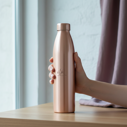 Hand holding a brushed copper Ayurvedic water vessel beside a softly lit window in a calm wellness setting. — for Carpe Diem Dream