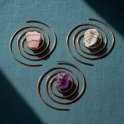 Copper spiral crystal water chargers featuring clear quartz, rose quartz, and amethyst displayed on deep teal textured linen. — for Carpe Diem Dream