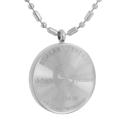A close-up of the back of a silver defense pendant necklace showing engraved text reading “Scalar Energy defense pendant SN 72036 Japanese Technology” with a circular spiral pattern on a clean white background. — for Carpe Diem Dream