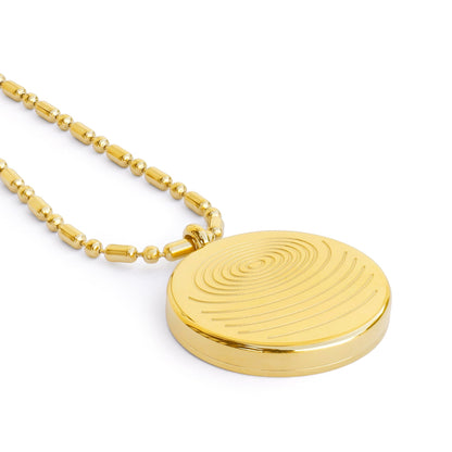 A close-up of a circular defense pendant with a gold textured disc and matching gold beaded chain displayed on a clean white background, highlighting surface detail and finish. — for Carpe Diem Dream