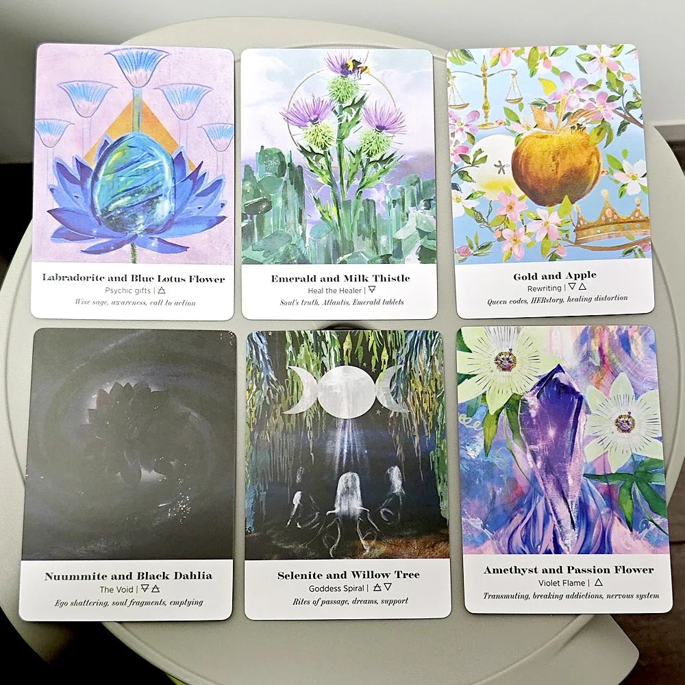 Six Earth Alchemy Oracle cards featuring colorful botanical and crystal illustrations are displayed in two rows on a neutral surface, showing detailed card artwork. — for Carpe Diem Dream