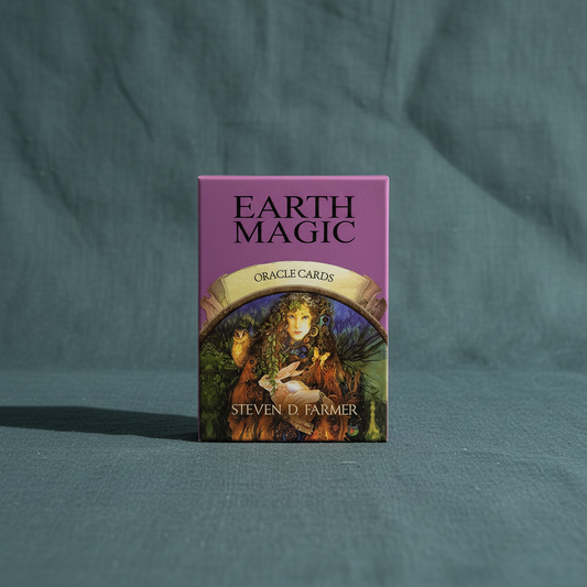 Earth Magic Oracle Deck box by Steven D. Farmer displayed upright on a muted teal linen background with soft studio lighting. — for Carpe Diem Dream