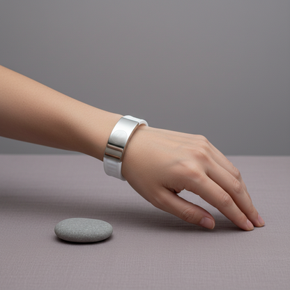 White EMF defense bracelet worn on a wrist, shown in a minimal setting to illustrate fit and scale with soft natural lighting. — for Carpe Diem Dream