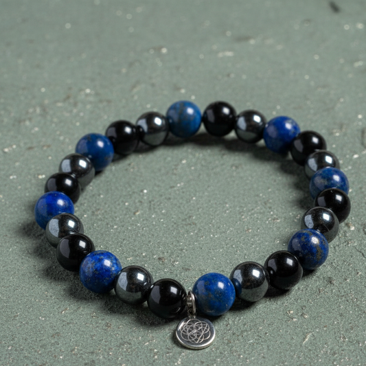 Lapis Lazuli, Onyx, and Hematite gemstone bracelet styled upright on muted sage surface with Tree of Life charm. — for Carpe Diem Dream