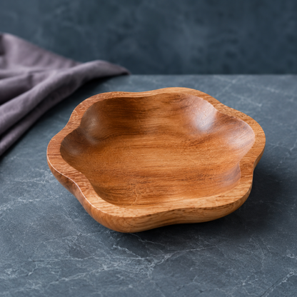 Hand-carved teak catch all dish professionally photographed on a cool blue-gray stone surface with a mauve linen accent. — for Carpe Diem Dream