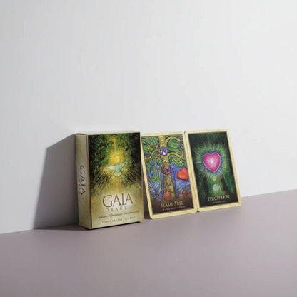A Gaia Oracle Cards deck box is displayed with three illustrated cards on a clean neutral surface in a minimal studio setting. — for Carpe Diem Dream