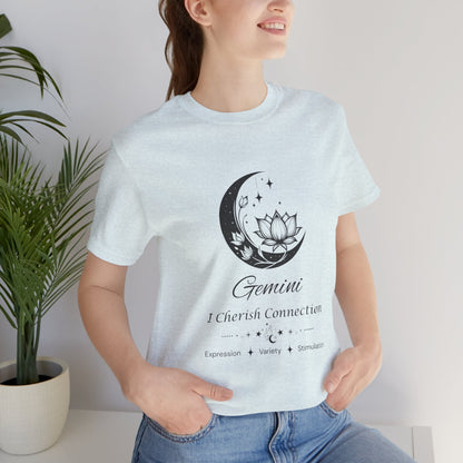 Model wearing a Heather Ice Blue Gemini Moon I Cherish Connection zodiac T-shirt with black moon-inspired lotus, floral, and celestial artwork. — for Carpe Diem Dream