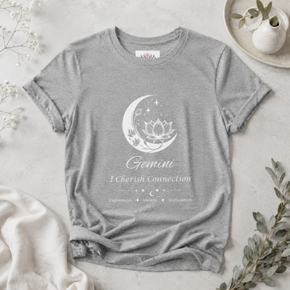 Gemini Moon I Cherish Connection zodiac T-shirt in Athletic Heather with white moon-inspired lotus, floral, and celestial artwork and Expression, Variety, Stimulation text, styled in a cool-toned studio botanical flat lay. — for Carpe Diem Dream