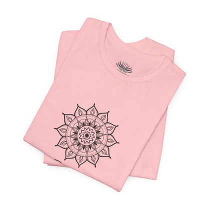 Gemini Sun I Think zodiac T-shirt in pink with black sun-inspired mandala artwork, shown folded with Carpe Diem Dream neck label in a supplier mockup. — for Carpe Diem Dream