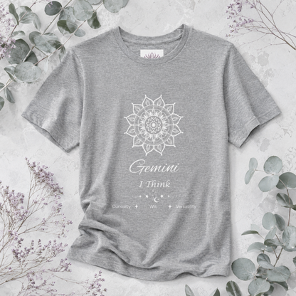 Gemini Sun I Think zodiac T-shirt in athletic heather with white sun-inspired mandala artwork and Curiosity, Wit, Versatility text, styled in a cool-toned studio botanical flat lay. — for Carpe Diem Dream