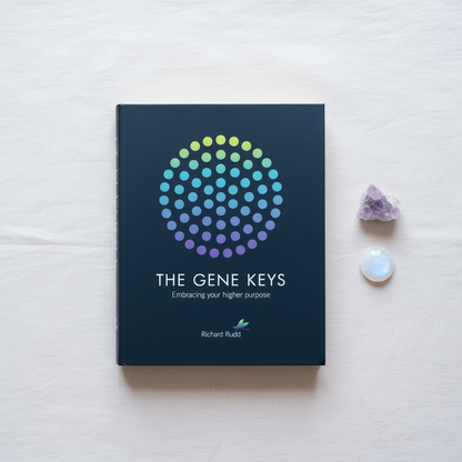 The Gene Keys: Embracing Your Higher Purpose by Richard Rudd displayed with amethyst and moonstone accents on a soft linen background. — for Carpe Diem Dream