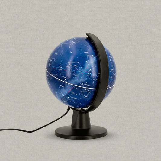 Six inch illuminated constellation globe displaying labeled zodiac star maps on a black stand with USB cord against a textured linen background — for Carpe Diem Dream