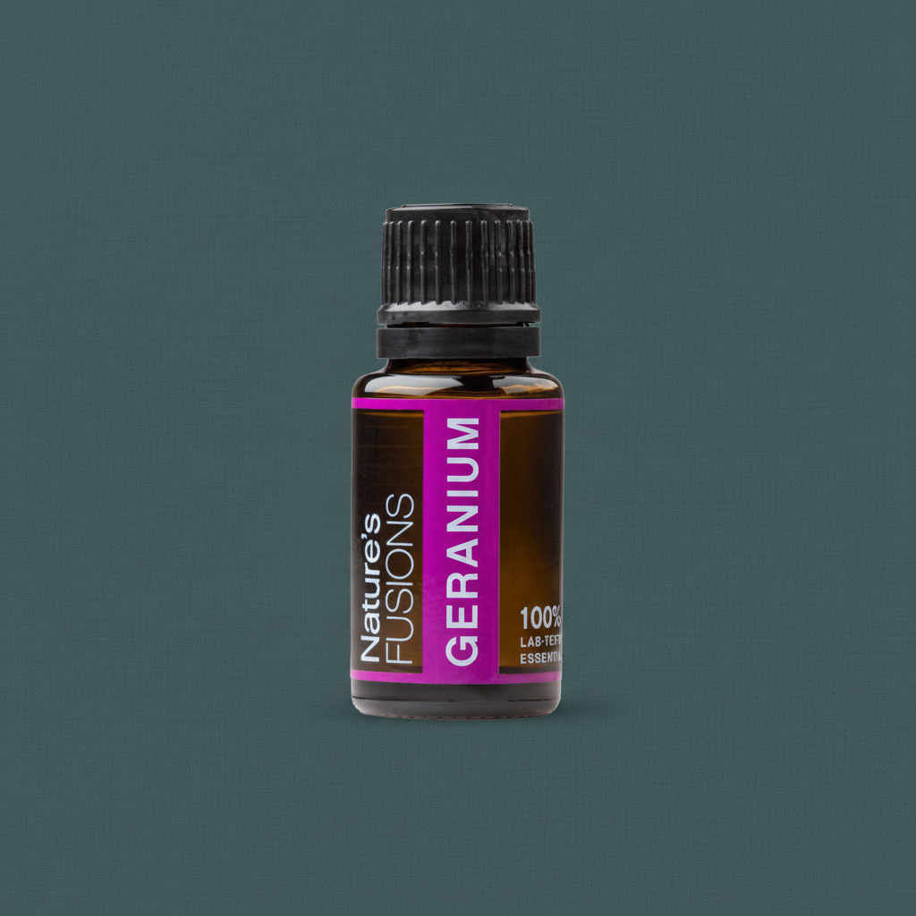 A 15ml amber glass bottle of Geranium essential oil with a black cap and magenta label displayed against a muted teal background. — for Carpe Diem Dream