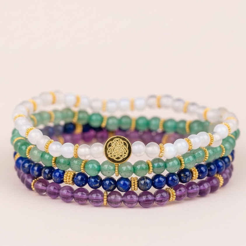 Multicolored gemstone luck bracelets shown in an extreme close-up on soft neutral surface. — for Carpe Diem Dream