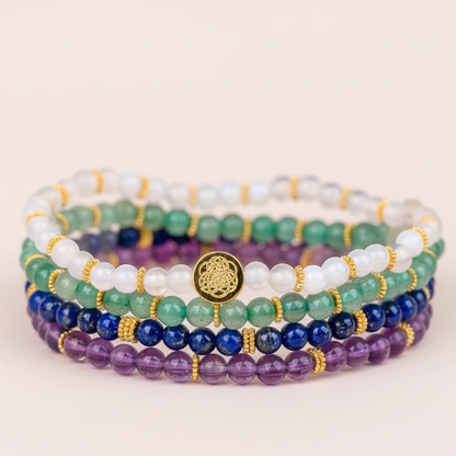Multicolored gemstone luck bracelets shown in an extreme close-up on soft neutral surface. — for Carpe Diem Dream
