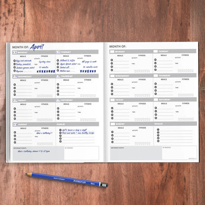 An open health and wellness planner showing weekly food and fitness tracking pages on a wooden desk with a pen. — for Carpe Diem Dream
