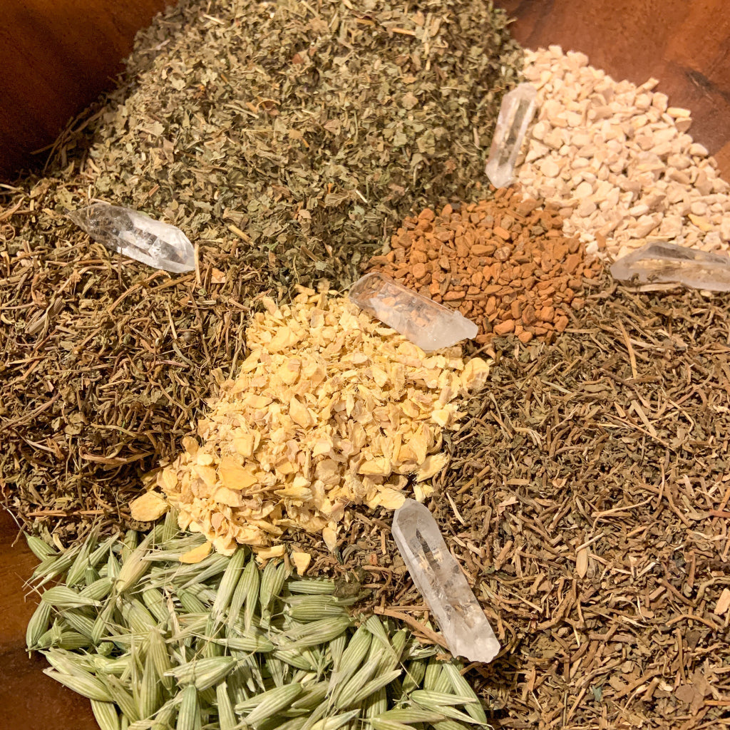 Organic ingredients and Clear Quartz crystals used in Highest Self Tea — Organic Crystal Infused, featuring Gotu Kola, Brahmi, Oat Tops, Ashwagandha, Lemon Balm, Ginger, Cinnamon, and Clear Quartz crystals displayed in a handcrafted ingredient blend. — for Carpe Diem Dream