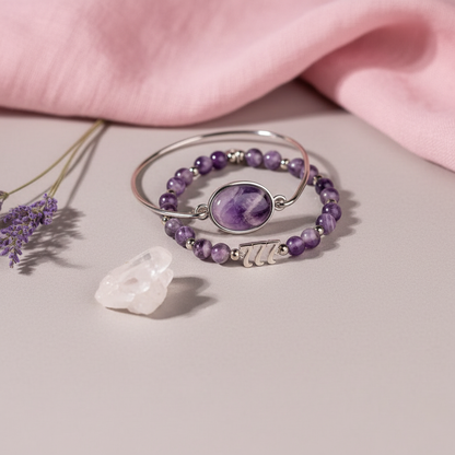 Amethyst 777 charm bracelet set displayed on soft blush drapery beside lavender sprigs and a glowing neutral light backdrop. — for Carpe Diem Dream