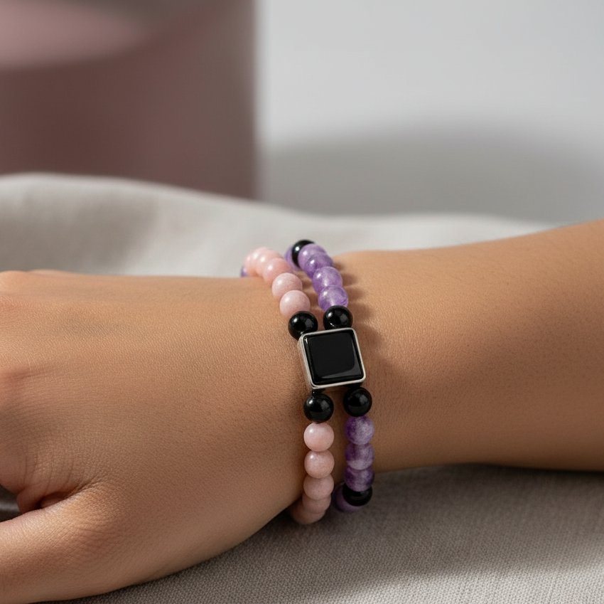 Feminine power healing bracelet in amethyst, pink opal, and onyx displayed on a wrist in a detailed close-up with soft diffused lighting — for Carpe Diem Dream