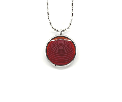 A rose coral ion glass defense pendant with a spiral design on a silver chain, displayed on a white background. — for Carpe Diem Dream