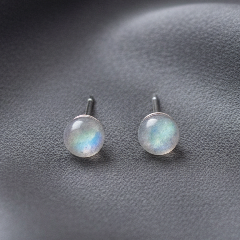 Silver labradorite stud earrings resting on a softly draped silk background. — for Carpe Die