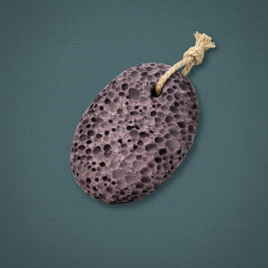 A natural volcanic lava pumice stone with a hanging rope displayed on a muted teal textured background. — for Carpe Diem Dream