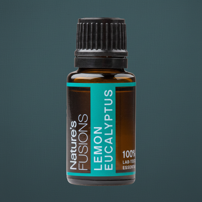 Close-up detail of a 15ml amber glass bottle of Lemon Eucalyptus essential oil showing the black cap and teal label against a muted teal background. — for Carpe Diem Dream