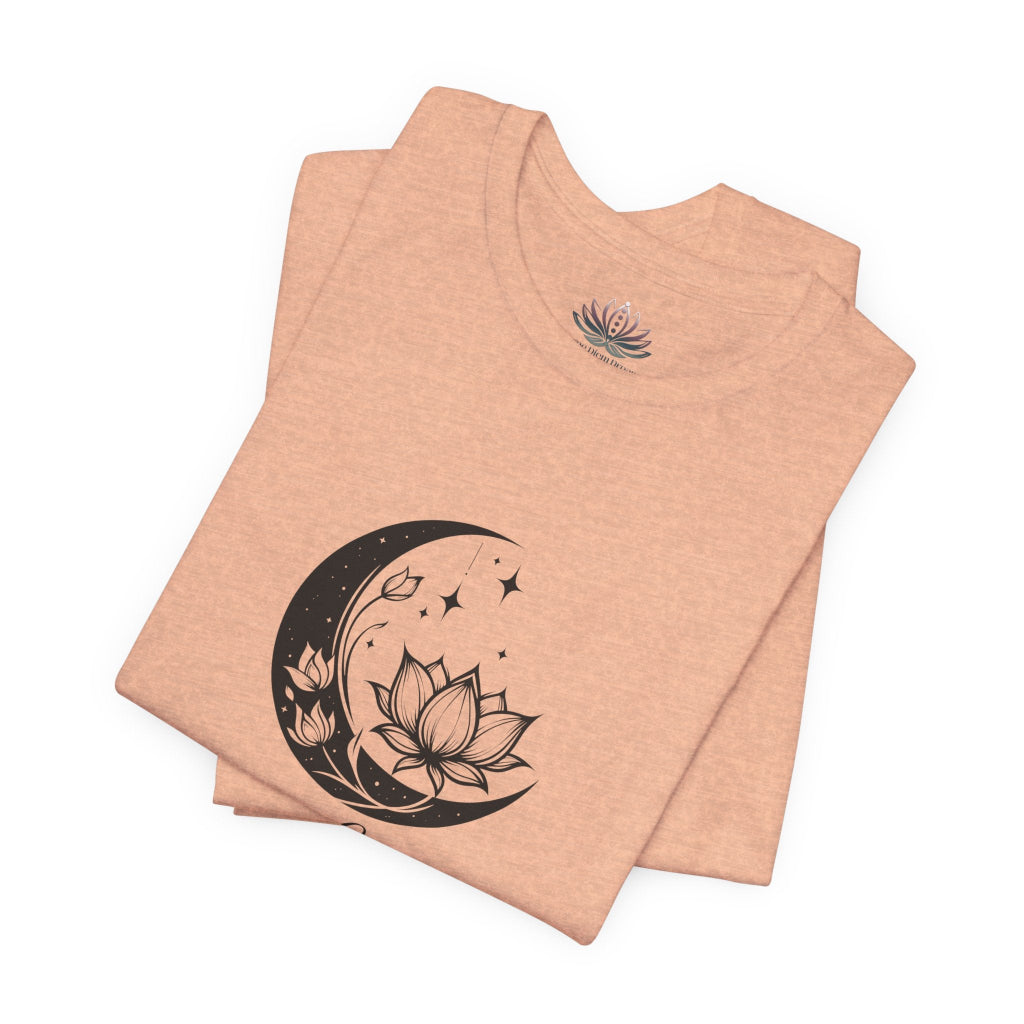 Leo Moon I Cherish Appreciation zodiac T-shirt in Heather Peach with black moon-inspired lotus, floral, and celestial artwork, shown folded in a supplier mockup. — for Carpe Diem Dream