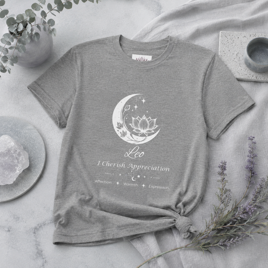 Leo Moon I Cherish Appreciation zodiac T-shirt in Athletic Heather with white moon-inspired lotus, floral, and celestial artwork and Affection, Warmth, Expression text, styled in a cool-toned studio botanical flat lay. — for Carpe Diem Dream