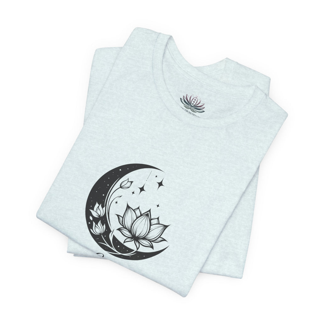 Libra Moon I Cherish Harmony zodiac T-shirt in Heather Ice Blue with black moon-inspired lotus, floral, and celestial artwork, shown folded in a supplier mockup. — for Carpe Diem Dream
