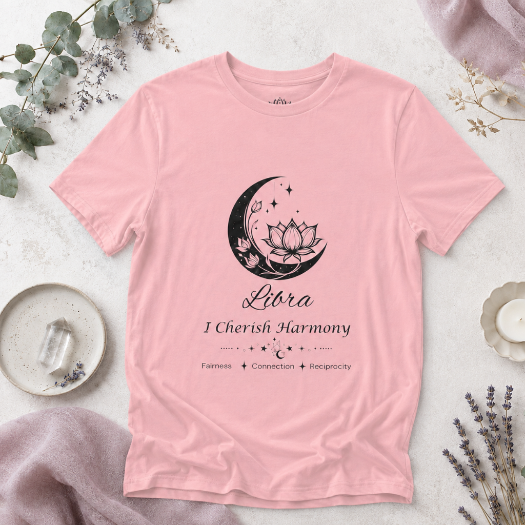 Libra Moon I Cherish Harmony zodiac T-shirt in pink with black moon-inspired lotus, floral, and celestial artwork and Fairness, Connection, Reciprocity text, styled in a cool-toned studio botanical flat lay. — for Carpe Diem Dream
