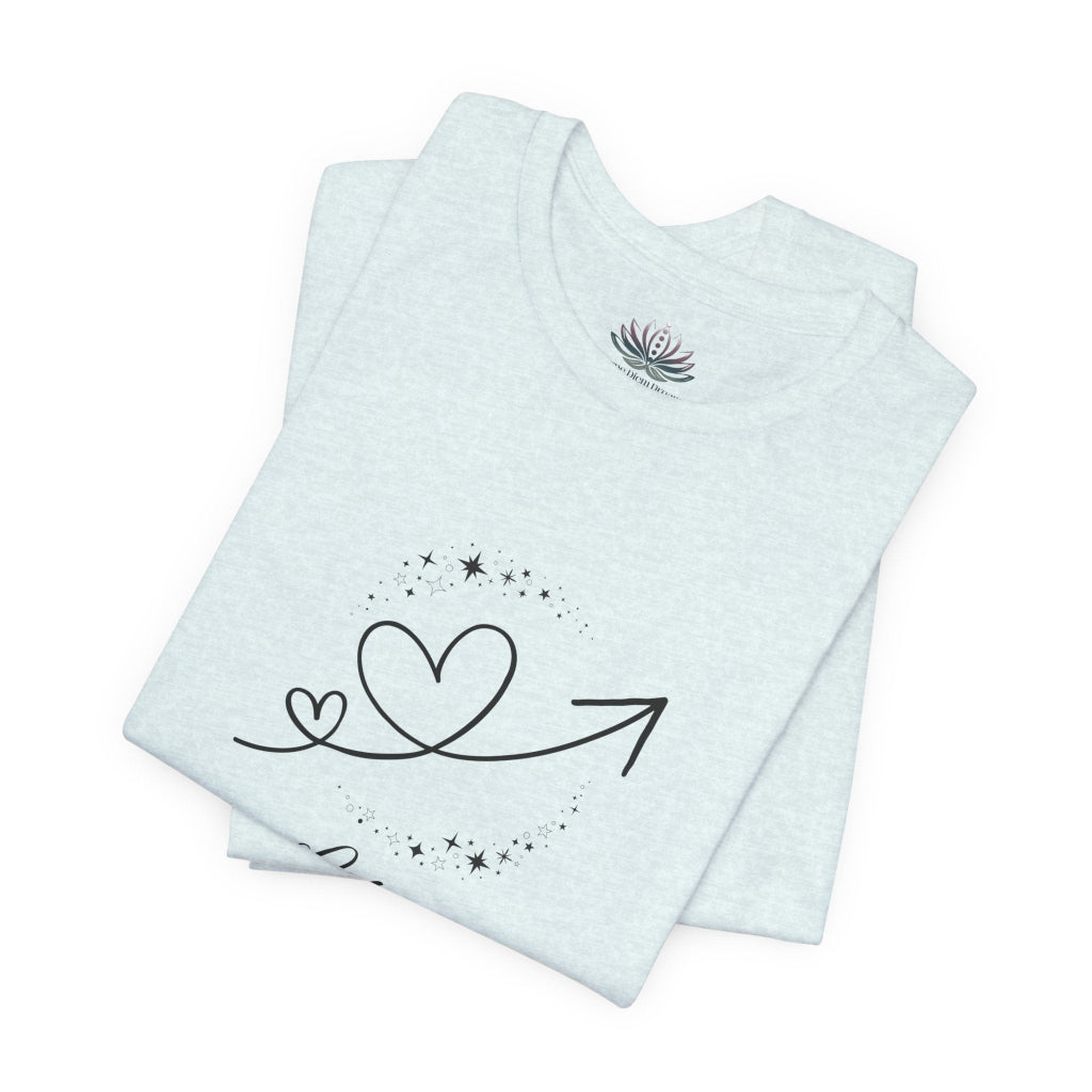 Libra Rising I Connect zodiac T-shirt in Heather Ice Blue with black celestial heart and arrow artwork, shown folded in a supplier mockup. — for Carpe Diem Dream