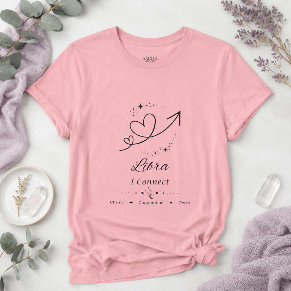 Libra Rising I Connect zodiac T-shirt in pink with black celestial heart and arrow artwork and Charm, Cooperation, Poise text, styled in a cool-toned studio botanical flat lay. — for Carpe Diem Dream