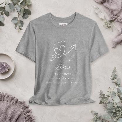Libra Rising I Connect zodiac T-shirt in Athletic Heather with white celestial heart and arrow artwork and Charm, Cooperation, Poise text, styled in a cool-toned studio botanical flat lay. — for Carpe Diem Dream