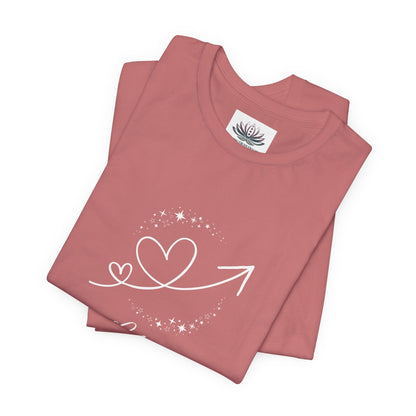 Libra Rising I Connect zodiac T-shirt in mauve with white celestial heart and arrow artwork, shown folded in a supplier mockup. — for Carpe Diem Dream