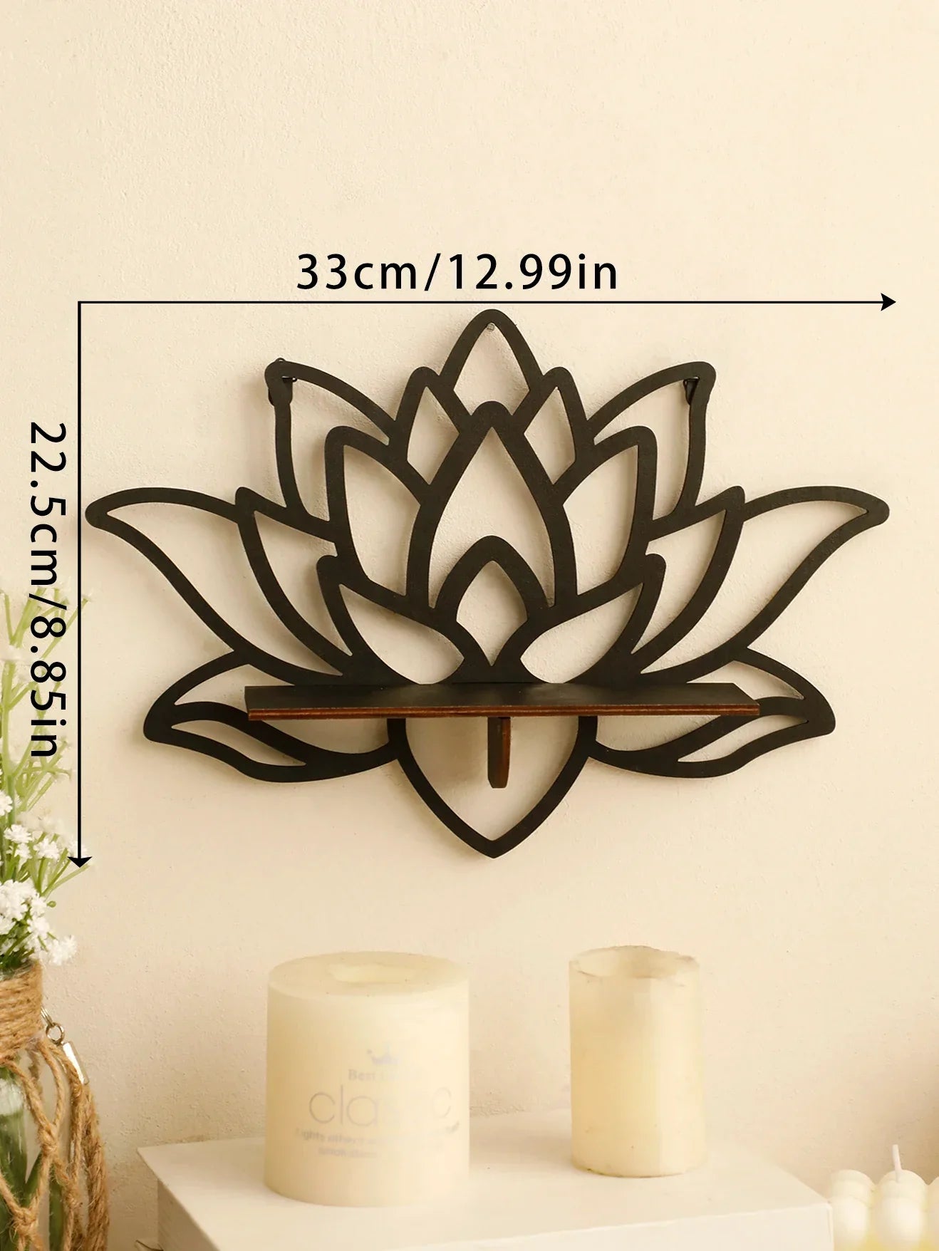 A black lotus-shaped wall shelf mounted on a wall with visible dimensions labeled approximately 33 cm wide and 22.5 cm tall above candles on a surface below. — for Carpe Diem Dream