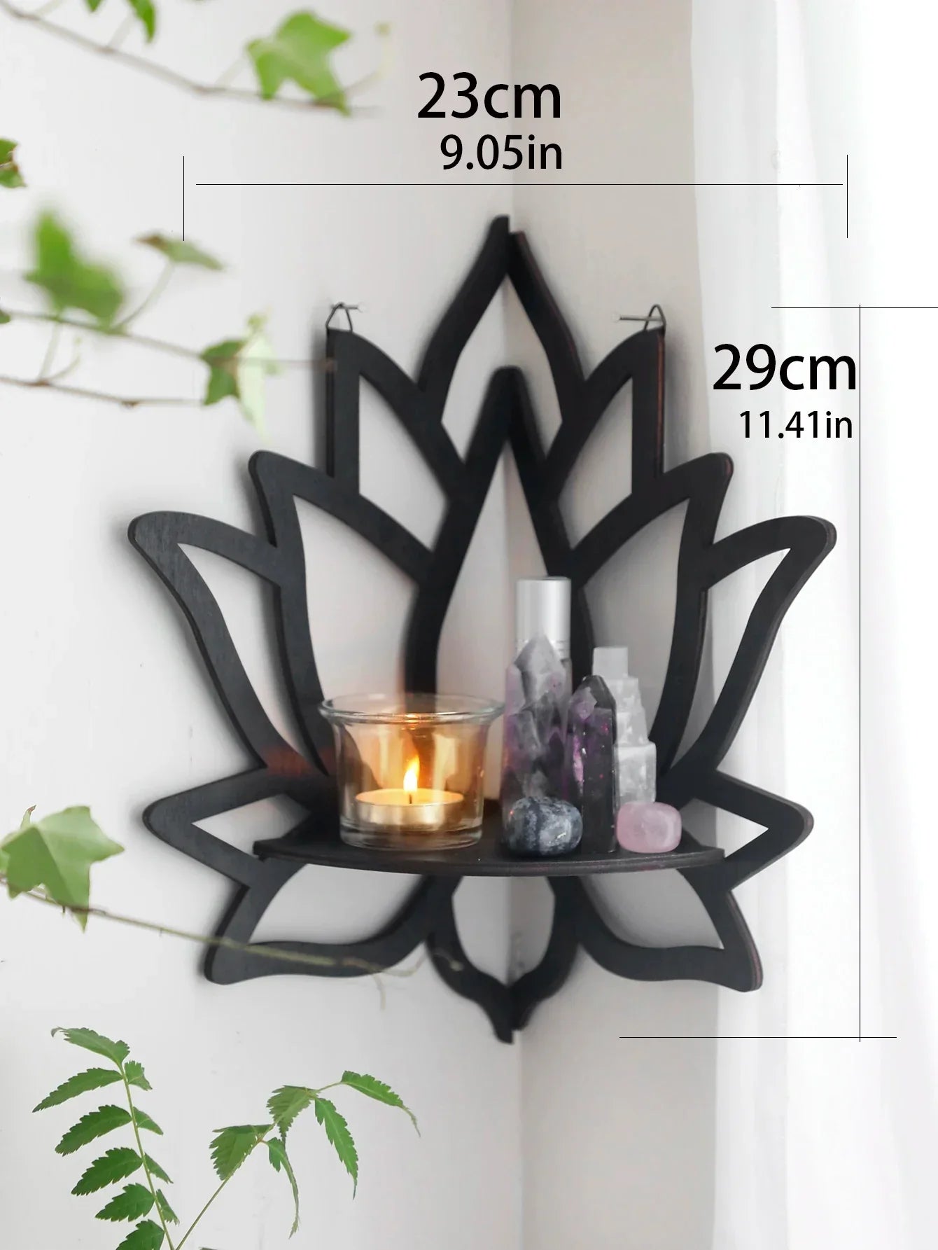 A black lotus-shaped wall shelf displayed on a neutral wall with a layered design and decorative items placed on the shelf. — for Carpe Diem Dream