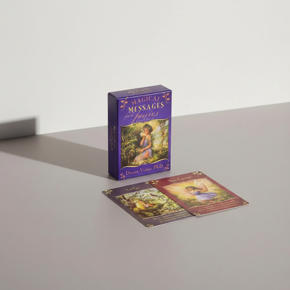 A Magical Messages From The Fairies Oracle deck box displayed upright with two oracle cards laid in front on a clean neutral studio surface with soft lighting. — for Carpe Diem Dream
