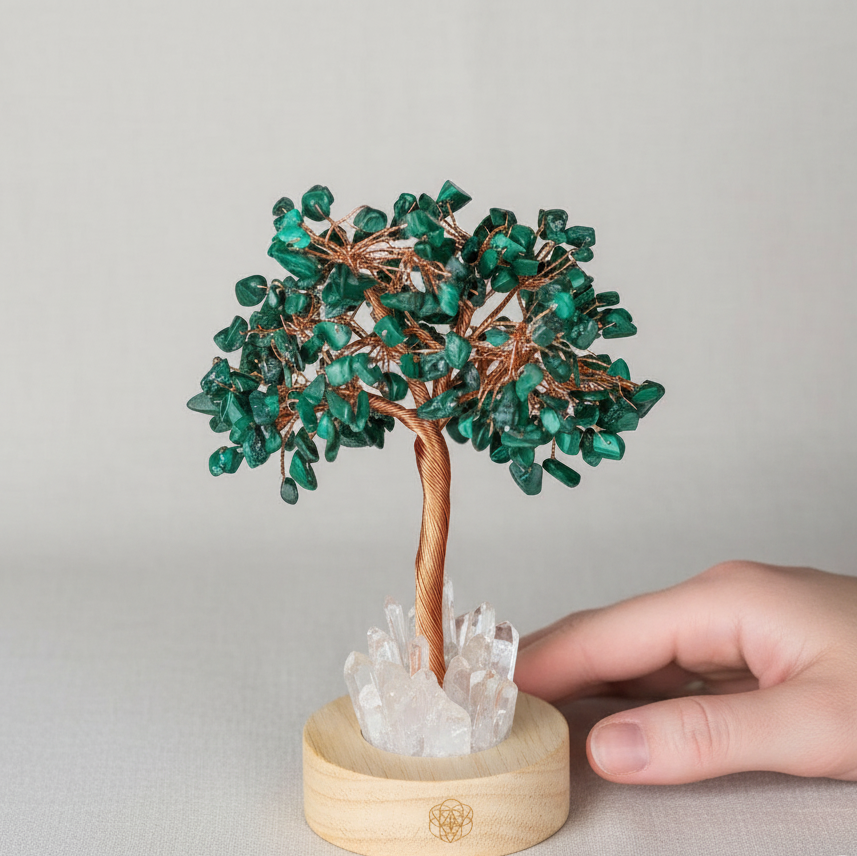 A malachite crystal tree lamp with copper wire branches and a clear quartz base shown with a hand for size reference against a neutral background. — for Carpe Diem Dream