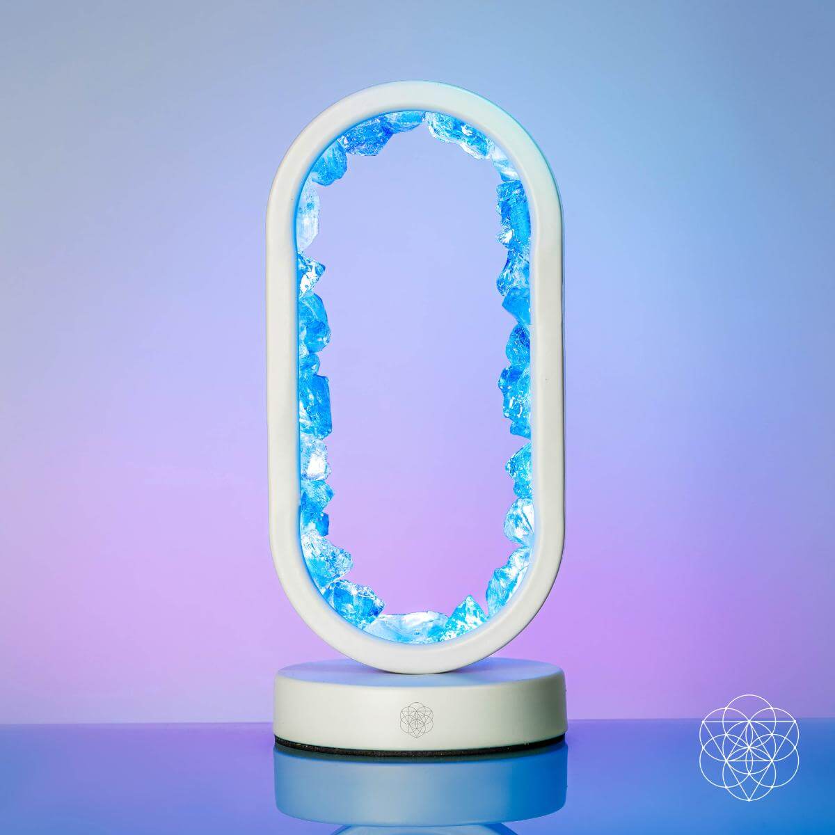 Blue Aura Clear Quartz Lamp illuminated in ambient mode, showcasing calming cool tones for clarity and motivation.