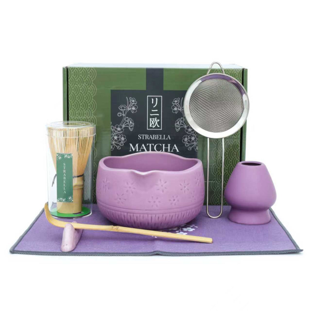 Purple Matcha Ritual Set with bamboo whisk, ceramic tea bowl, whisk holder, scoop, strainer, and gift box displayed on a matching purple tea towel. — for Carpe Diem Dream